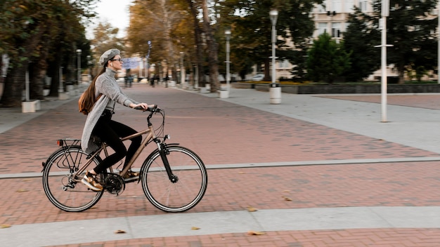 Woman standing on the bicycle long shot