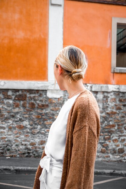 Woman standing by the sidewalk facing to the side