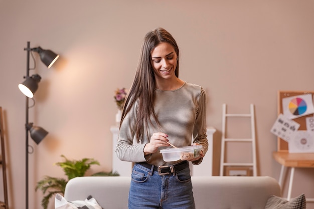 Woman standing and eating in lunch break