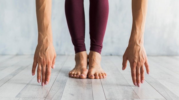 Free Photo woman standing in a forward bend pose