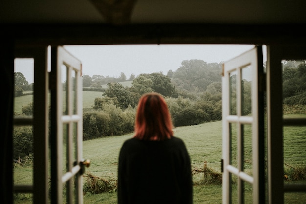 Free photo woman standing in front of the house