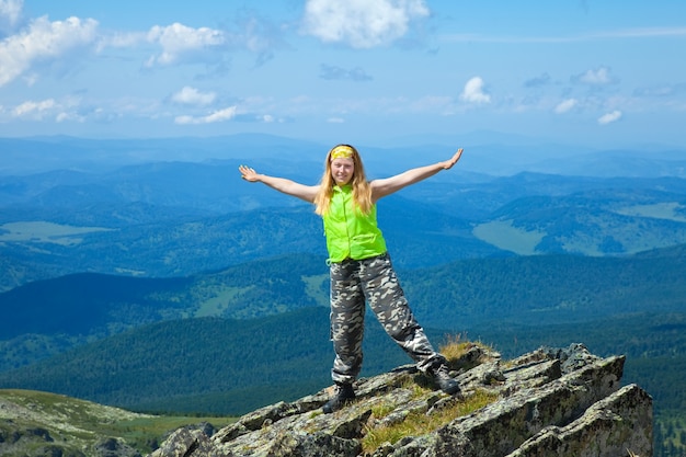 woman standing on  mountain peak