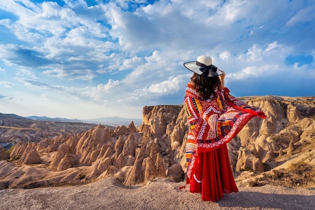 Free photo woman standing on mountains in cappadocia, turkey.