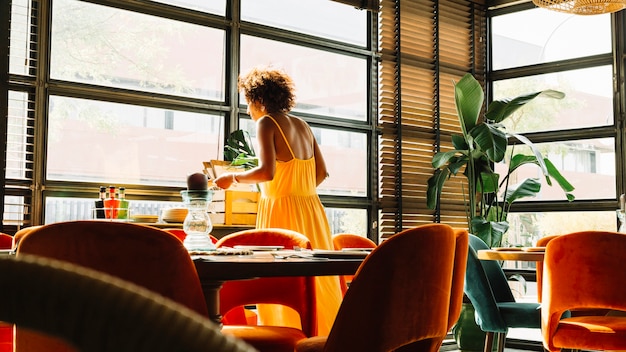 Free Photo woman standing near the window in the restaurant