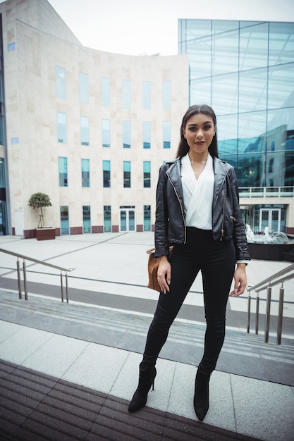 Free photo woman standing outside the office building