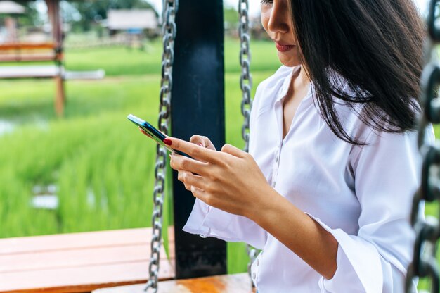 Woman standing on a smartphone