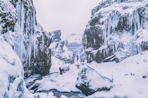 Free Photo woman standing on snow-covered cliff