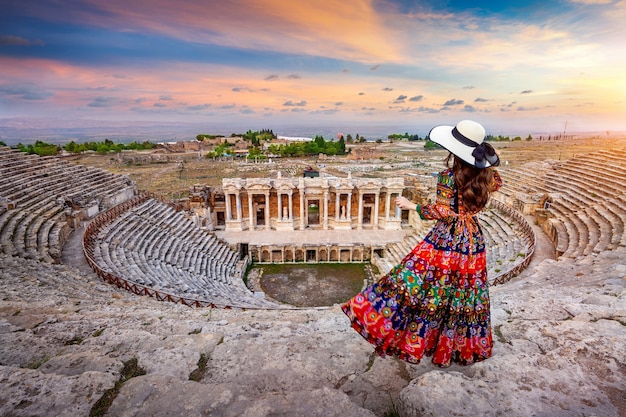 Woman standing on theater of Hierapolis ancient city in Pamukkale, Turkey.