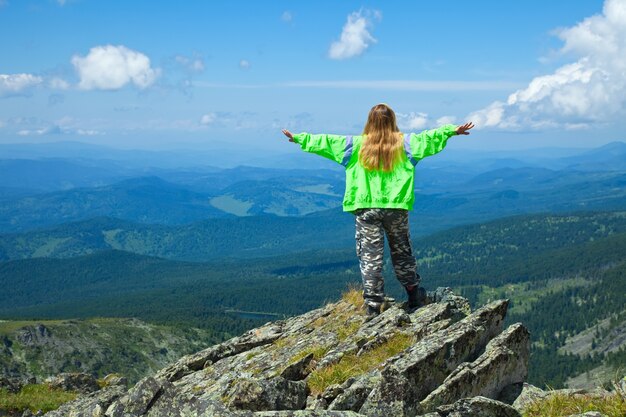 woman  standing at top rock