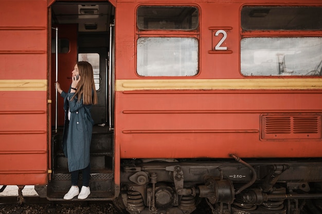 Woman standing in the train entrance and looking for someone