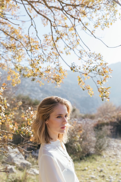 Free photo woman standing under  tree