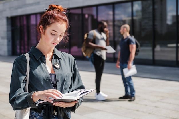 Free Photo woman standing with book