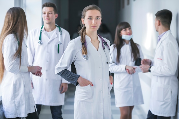 Free Photo woman standing with medic colleagues