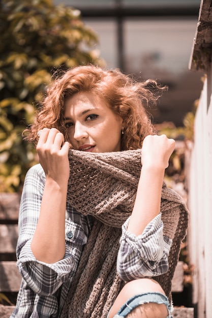 Free photo woman on steps holding scarf