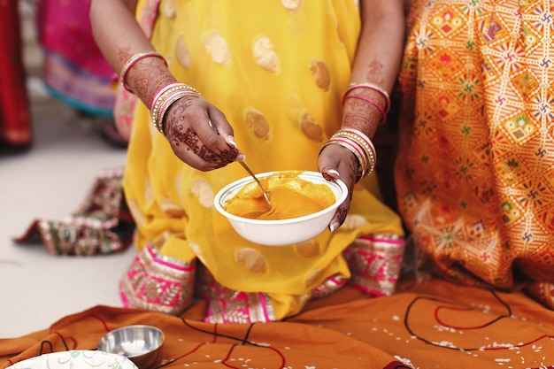 Free Photo woman stirs turmeric paste in the white bowl