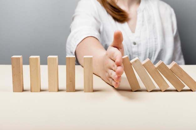 Woman stopping the wooden pieces of fall concept