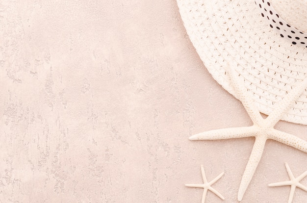 Woman straw hat with sea stars on table