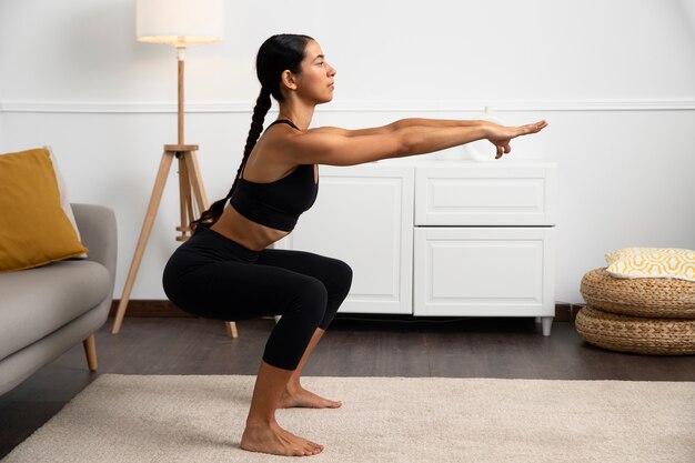 Woman strengthening the pelvic floor side view