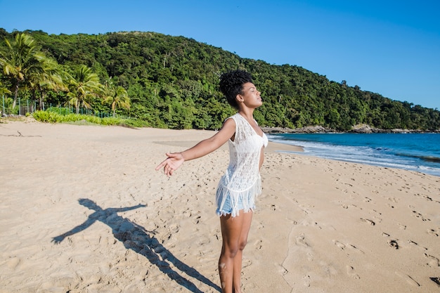 Woman stretching arms at the beach