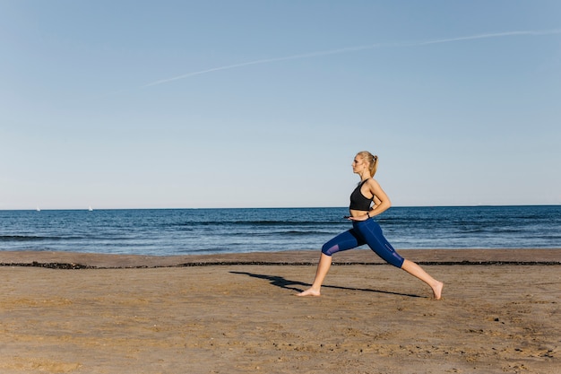 Woman stretching at the beach