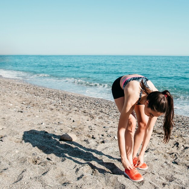 Woman stretching at the beach