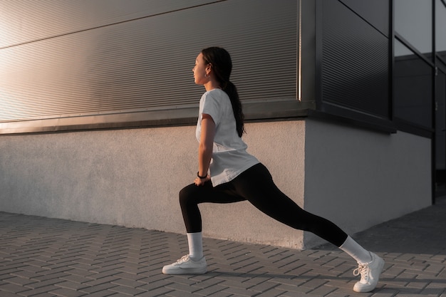 Woman stretching before working out outdoors