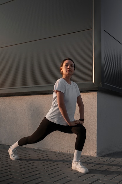 Woman stretching before working out outdoors