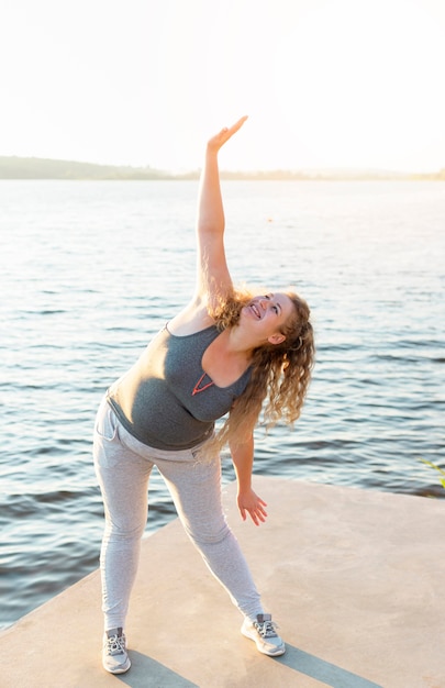 Woman stretching by the lake