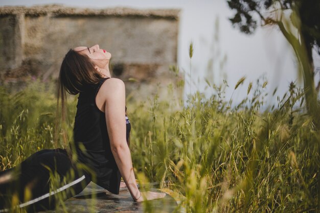 Free Photo woman stretching on field