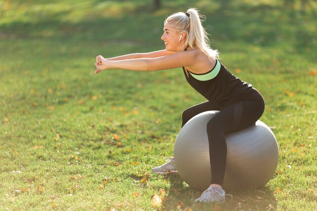 Woman stretching on a gym ball