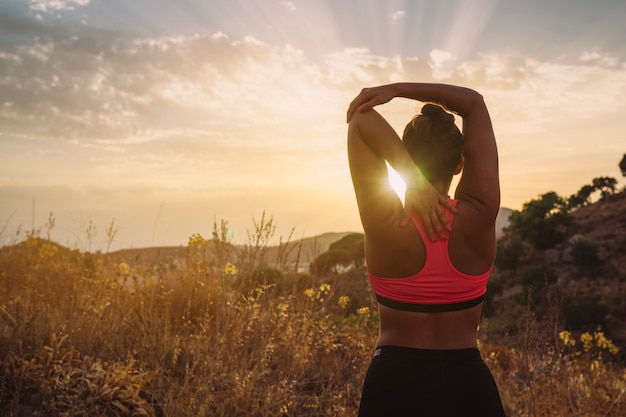 Woman stretching her arm and ejoying the views