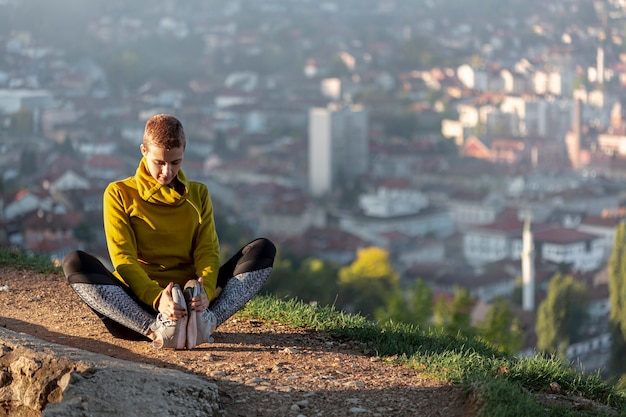 Woman stretching outdoors full shot