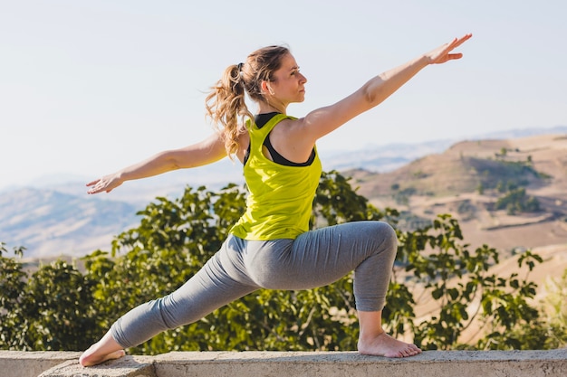 Free photo woman stretching and relaxing in nature