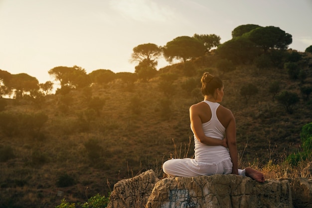 Free photo woman stretching and relaxing in the nature