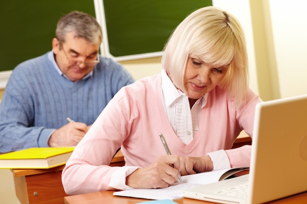 Woman studying with her husband background