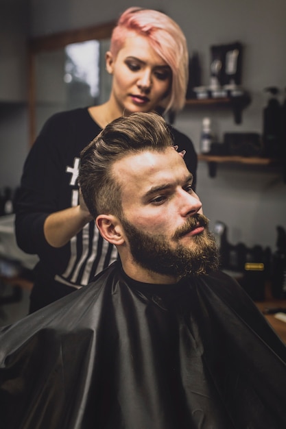 Free photo woman styling customer in salon