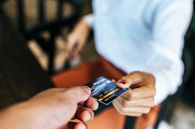 Woman submitting credit card to pay for goods