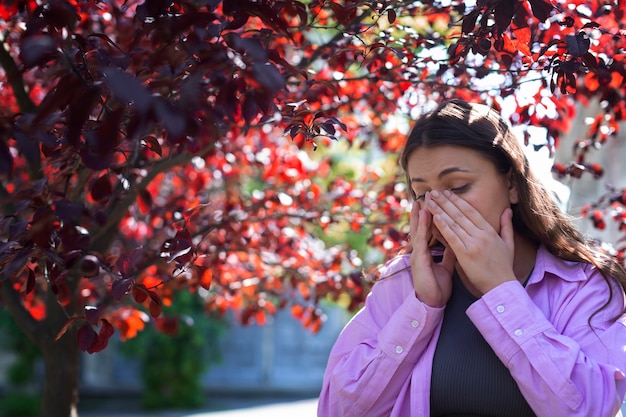 Woman suffering from allergies outside