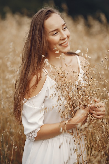 Free Photo woman in a summer field. brunette in a white dress. 