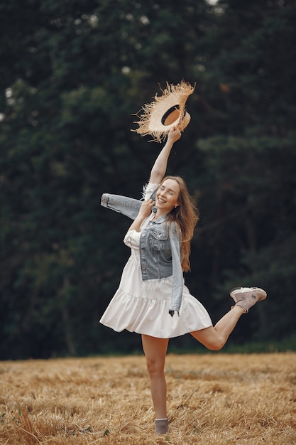 Free photo woman in a summer field. lady in a white dress.