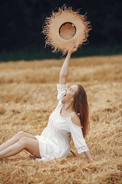 Woman in a summer field. Lady in a white dress. 