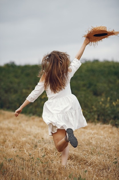 Free photo woman in a summer field. lady in a white dress.