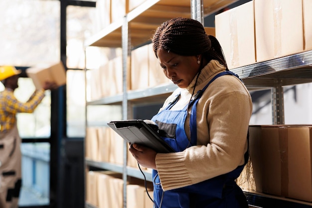 Woman supervising supply using barcode scanner and digital tablet