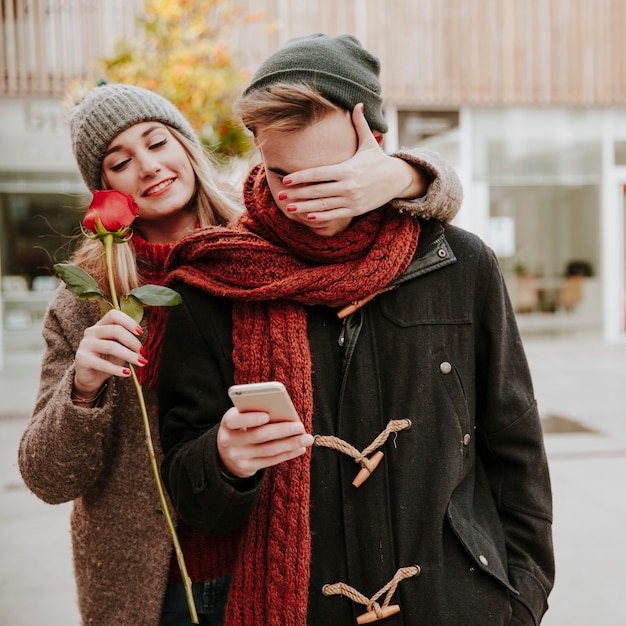 Free Photo woman surprising man with flower