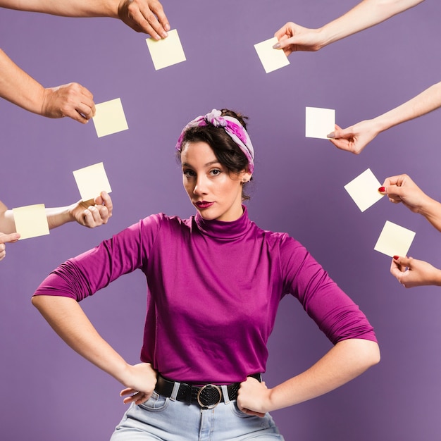 Free photo woman surrounded by hands and sticky notes