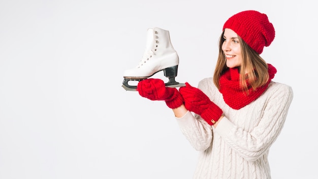 Free photo woman in sweater holding white skate