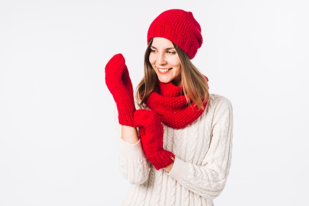 Free Photo woman in sweater putting gloves on 