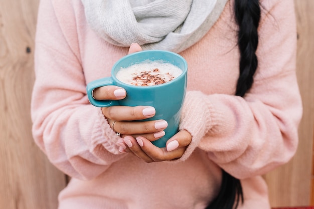 Free Photo woman in sweater with coffee cup