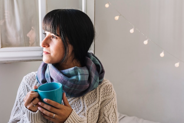 Free photo woman in sweater with cup