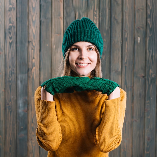 Free photo woman in sweater with hands under chin